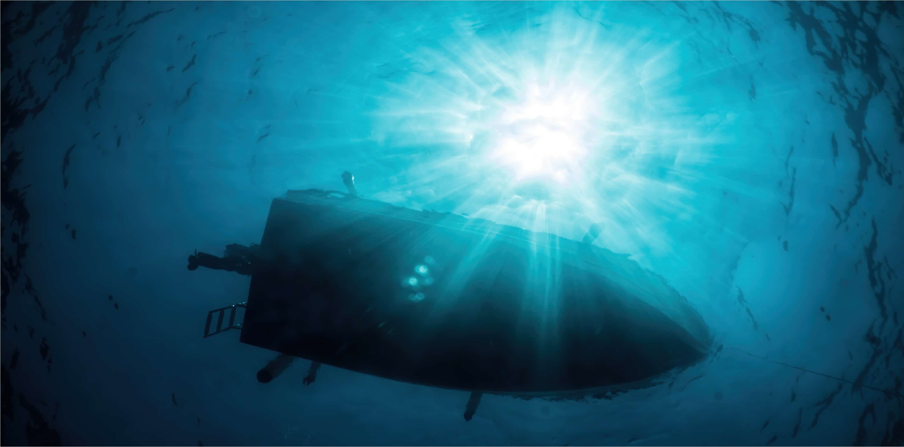 boat floating on the surface of the sea seen from below with high sunlight